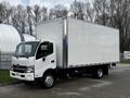 A white 2019 Hino 195 box truck with a large empty cargo area and a front cab featuring a simple design and clear headlights