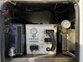 Inside a compartment of a 2018 Ford F-550 there is a Van Air Super Boost engine starting system featuring a digital display hoses and a pressure gauge