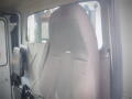 A driver seat of a 2008 International 7400 truck with a fabric cover and a simple design