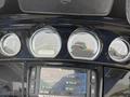 Dashboard of a 2017 Harley-Davidson FLHTKL featuring three round gauges and a central display screen with various media and navigation options