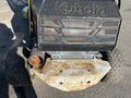 A 2010 Kubota F3990 lawn mower with a metallic front grille and rusty metal plate at the bottom visible along with large tires on either side