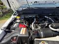Engine compartment of a 2014 Ford F-250 SD highlighting the battery and various engine components