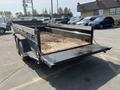 A 2024 Southland SL716-20K trailer with a steel frame and a flatbed design used for transporting materials like dirt or debris