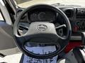 Steering wheel of a 2018 Hino 195 with dashboard instruments and controls visible in the foreground
