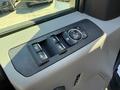 Interior control panel of a 2017 Ford F-350 SD featuring window switches and a dial for mirror adjustments