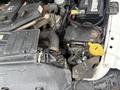 A close-up view of the engine compartment of a 2011 Dodge Ram 5500 showing various components like the battery and wiring near the engine