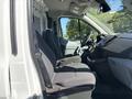 Interior of a 2016 Ford Transit showing two front seats and a steering wheel with dashboard and controls visible