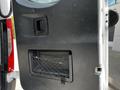 The interior panel of a 2019 Mercedes-Benz Sprinter door featuring a handle and a storage net at the bottom