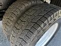 Close-up of the tread on two large tires mounted on a 2007 GMC W3500 showcasing a detailed pattern designed for traction and stability