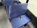 Two blue fabric seats with seatbelts in a Chevrolet Express vehicle interior