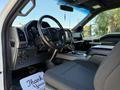 Interior view of a 2018 Ford F-150 showing the steering wheel dashboard and front seats with a center console