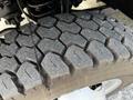 Close-up of a tire tread on a 2016 Ford F-550 showing a rugged pattern with significant wear and depth