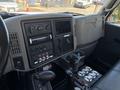 Interior dashboard of a 2008 International DuraStar featuring controls gauges and a radio with a cupholder and several buttons