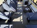 Interior of a 2017 Chevrolet Express featuring several blue seats and a spare tire on the floor