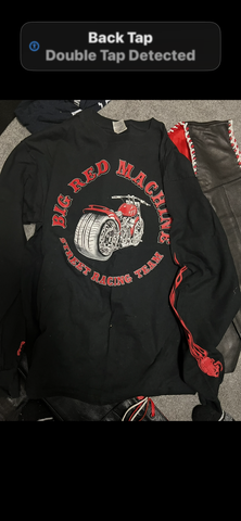 Various Big Red Machine clothing featuring a black long-sleeve shirt with a graphic design of a motorcycle and the words Big Red Machine Street Racing Team in bold red lettering