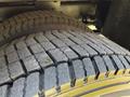 Close-up of the tread pattern on two large tires of a 2023 Ford F-550 showing deep grooves designed for traction