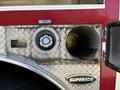 Close-up of a 2006 Emergency One Fire Truck featuring a diesel fuel cap a circular opening and a textured metallic surface with the word Superior displayed