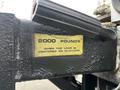 A metal plate attached to a Hino 268 truck bed displaying the text 2000 POUNDS WHEN THE LOAD IS CENTERED ON PLATFORM