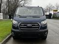 Front view of a blue 2020 Ford Transit van featuring a chrome grille and large side mirrors