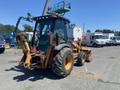 A 2008 Case Super 580M backhoe loader features large rear tires a cab with a protective frame and front loader arms ready for operation