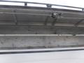 A storage compartment in a 2015 Chevrolet Silverado 1500 with metal shelves and a sliding door mechanism