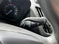 Close-up of the control stalk on a 2016 Ford Transit Connect steering column featuring symbols for wipers and indicators