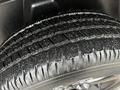 Close-up of a wet tire with deep grooves and treads mounted on a 2022 RAM 1500 Classic wheel