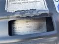 2005 Chevrolet Express with a visible label detailing inspection information serial number and specifications