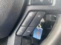 Close-up of the steering wheel controls of a 2017 Ford F-550 showing buttons for volume a phone call and other functions
