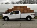 A white 2016 Ford F-150 pickup truck parked in profile view with a 4x4 badge on the side