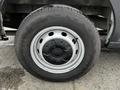 A close-up view of a tire and wheel assembly from a 2021 Ford Transit showing a black and gray wheel design with a textured surface