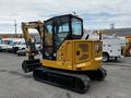 A 2024 Caterpillar 306 compact excavator featuring a yellow body with black tracks and an enclosed cab designed for construction and excavation tasks