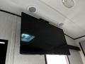 A flat-screen television mounted on a wall inside a 2022 Heartland Torque trailer