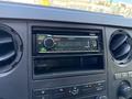 Dashboard of a 2012 Ford F-450 SD showing a Kenwood car stereo with a display indicating it is connecting