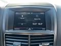 A digital dashboard display of a 2013 Lincoln MKT showing time temperature and navigation options