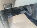 The footwell of a 2014 Ford F-250 SD showing the brake and accelerator pedals with a rubber mat covering the floor