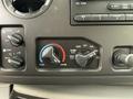 Dashboard controls of a 2011 Ford Econoline showing knobs for temperature adjustment and air circulation settings