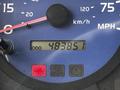 Close-up of a vehicle's speedometer displaying a speedometer reading and odometer at 483851 km and a park indicator