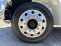 A close-up of a silver wheel with multiple bolt holes and a shiny rim on a 2008 International DuraStar truck
