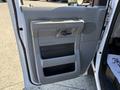 The image shows the interior door panel of a 2011 Ford Econoline featuring a handle and storage compartments