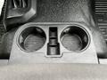 A close-up view of the cup holder in a 2017 Ford F-550 featuring two circular compartments with a textured surface