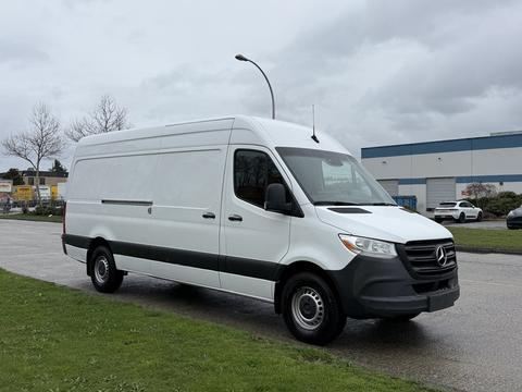 A 2019 Mercedes-Benz Sprinter van with a white exterior and black accents parked on a road