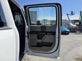 A 2017 Ford F-350 SD door is open showcasing the interior door panel with a black and gray design and controls
