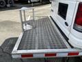 A white 2008 Ford Econoline with a metal step stool attached to its rear flatbed designed for loading and unloading items