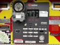 Control panel of a 2009 Spartan Gladiator featuring various levers switches gauges and warning labels