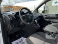 Interior view of a 2016 Ford Transit Connect showing the steering wheel dashboard and front seats featuring a modern design and fabric upholstery