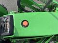 Top view of a green 2003 John Deere 790 tractor's engine cover featuring a fuel cap and control panel with gauges and switches