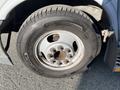 A close-up of a tire mounted on a silver wheel of a 2018 Chevrolet Express showing the tread and bolt pattern