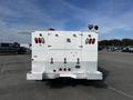 White 2017 Ford F-350 SD with a specialized utility body featuring red taillights and a hitch at the rear