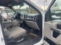 The interior of a 2017 Ford F-550 with a spacious front cabin featuring seats and a dashboard displaying controls and a screen